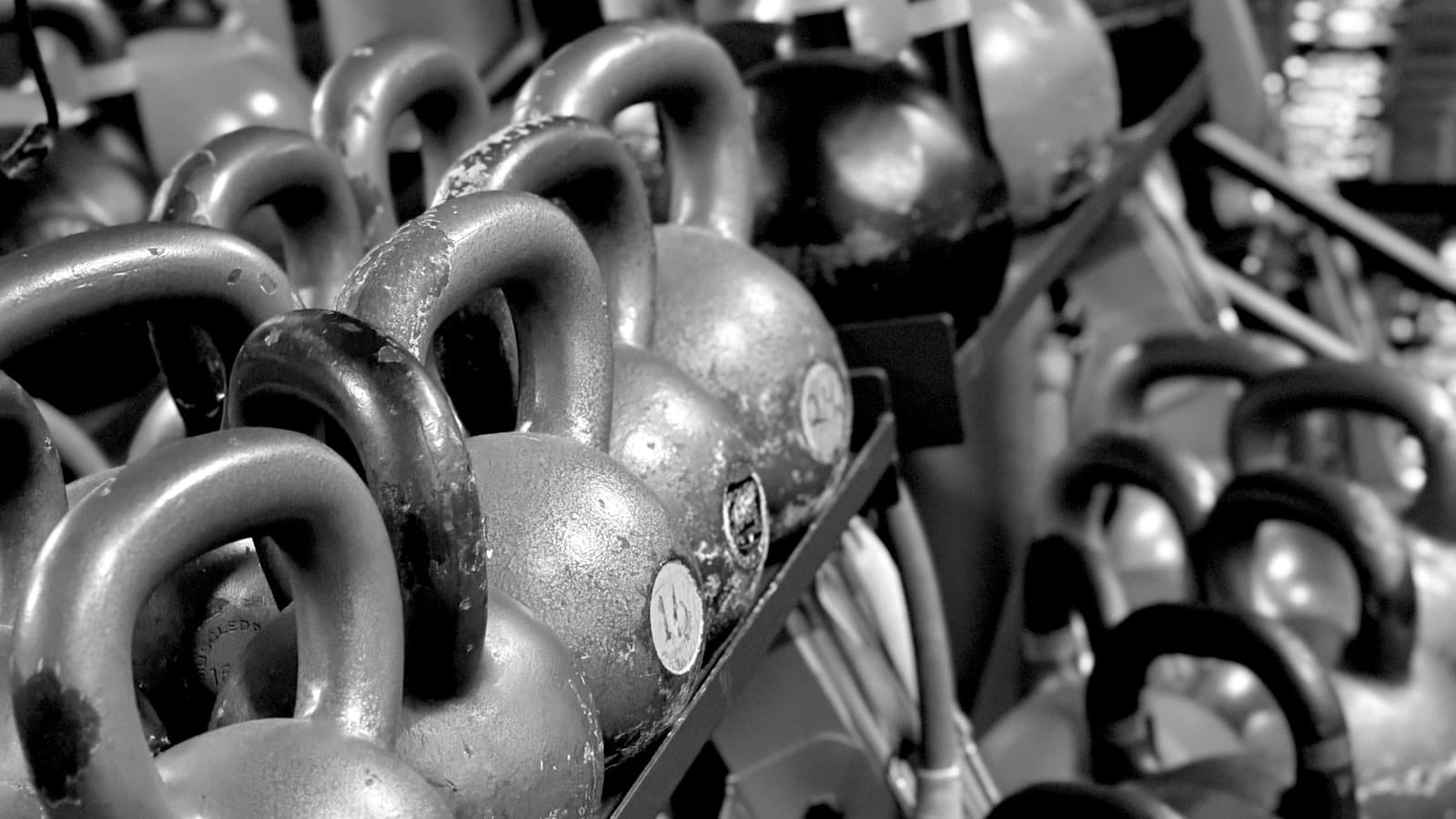 Rows of kettlebells racked in the studio