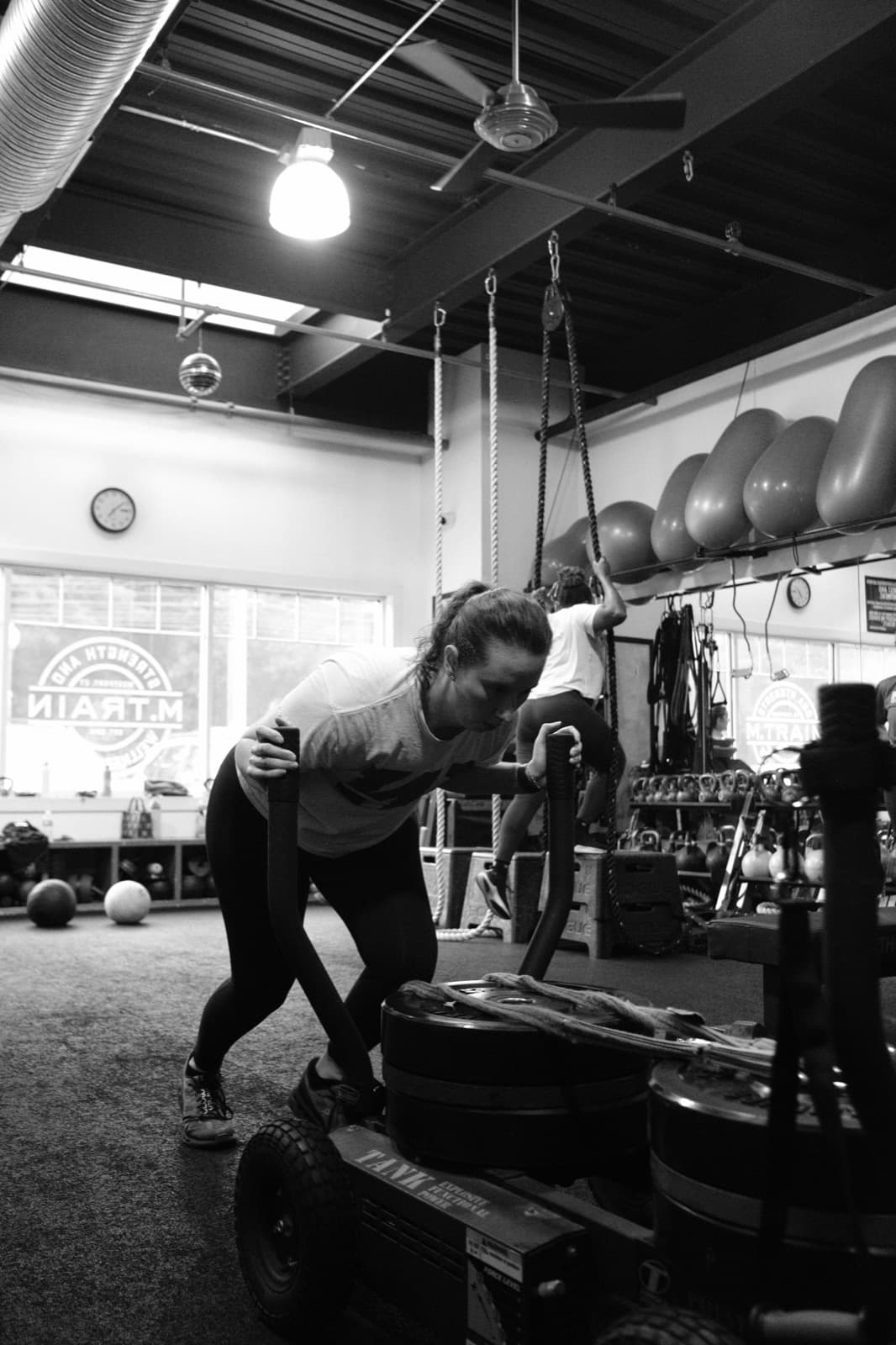 Sled push across the studio floor during a training session